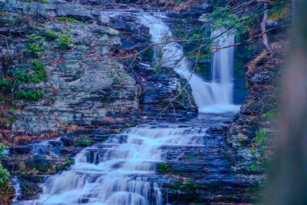 Close view of the natural Waterfall Wonder waterfall cascading over layered rock.