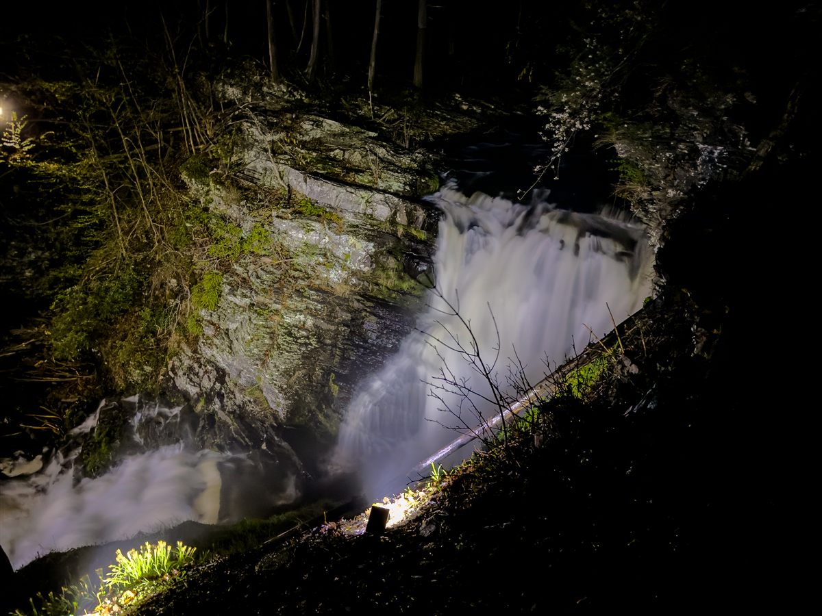 Waterfall illuminated at night in the forest at Waterfall Wonder.